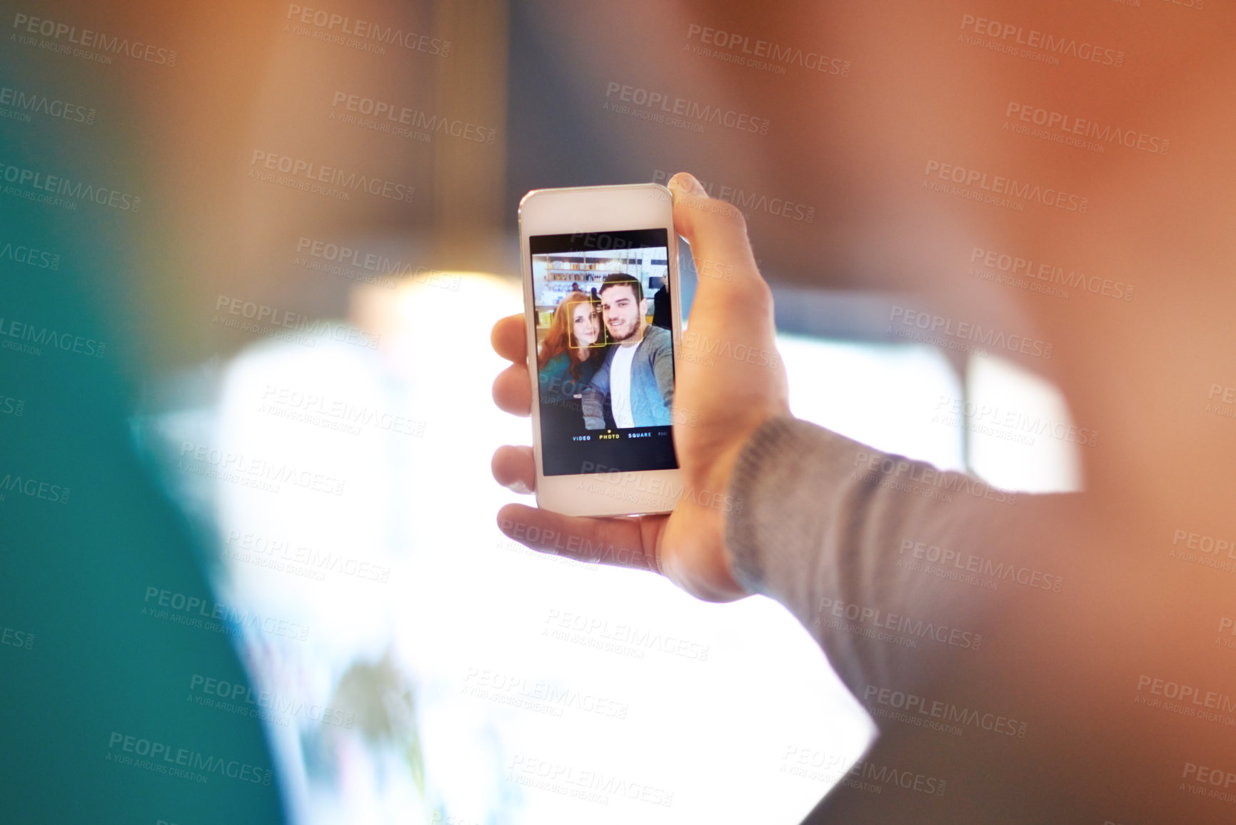 Buy stock photo Shot of a young couple taking a photo of themselves while on a date at a cafe