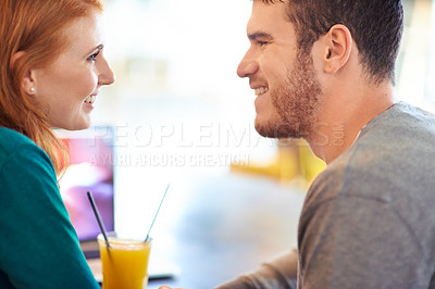 Buy stock photo Happy couple, smile and eye contact in cafe with love, romance and affection on anniversary date. Romantic, man and woman in restaurant bonding with juice, beverage and laughter in relationship 