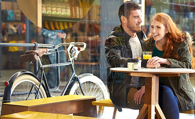 Buy stock photo Cropped shot of a happy young couple on a date at a cafe