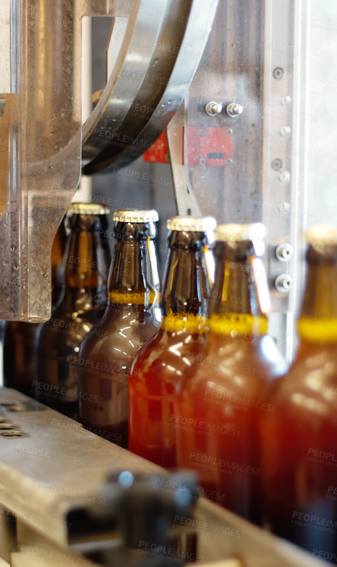 Buy stock photo Shot of beer bottles on a production line at a brewery