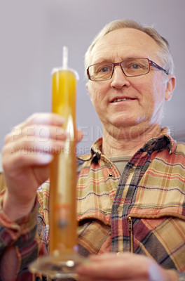 Buy stock photo Beer, brewing and glass tube with a man in a plant, factory or warehouse for the production of alcohol. Manufacturing, industry and career with a male brewer in a distillery for quality control