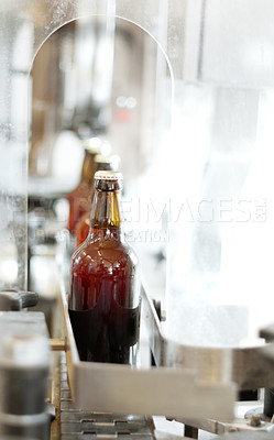 Buy stock photo Shot of beer bottles on a production line at a brewery