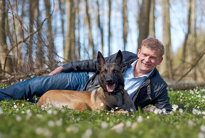 Buy stock photo A man and his dog sitting in the forest together