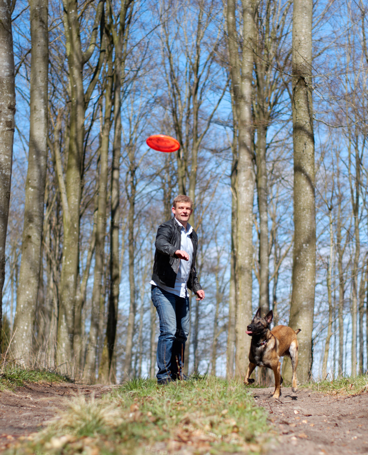 Buy stock photo Man, dog and park with flying disc for game, learning and running in forrest for health, exercise or freedom. Pet animal, plastic plate and workout for body, care and adventure with puppy in woods