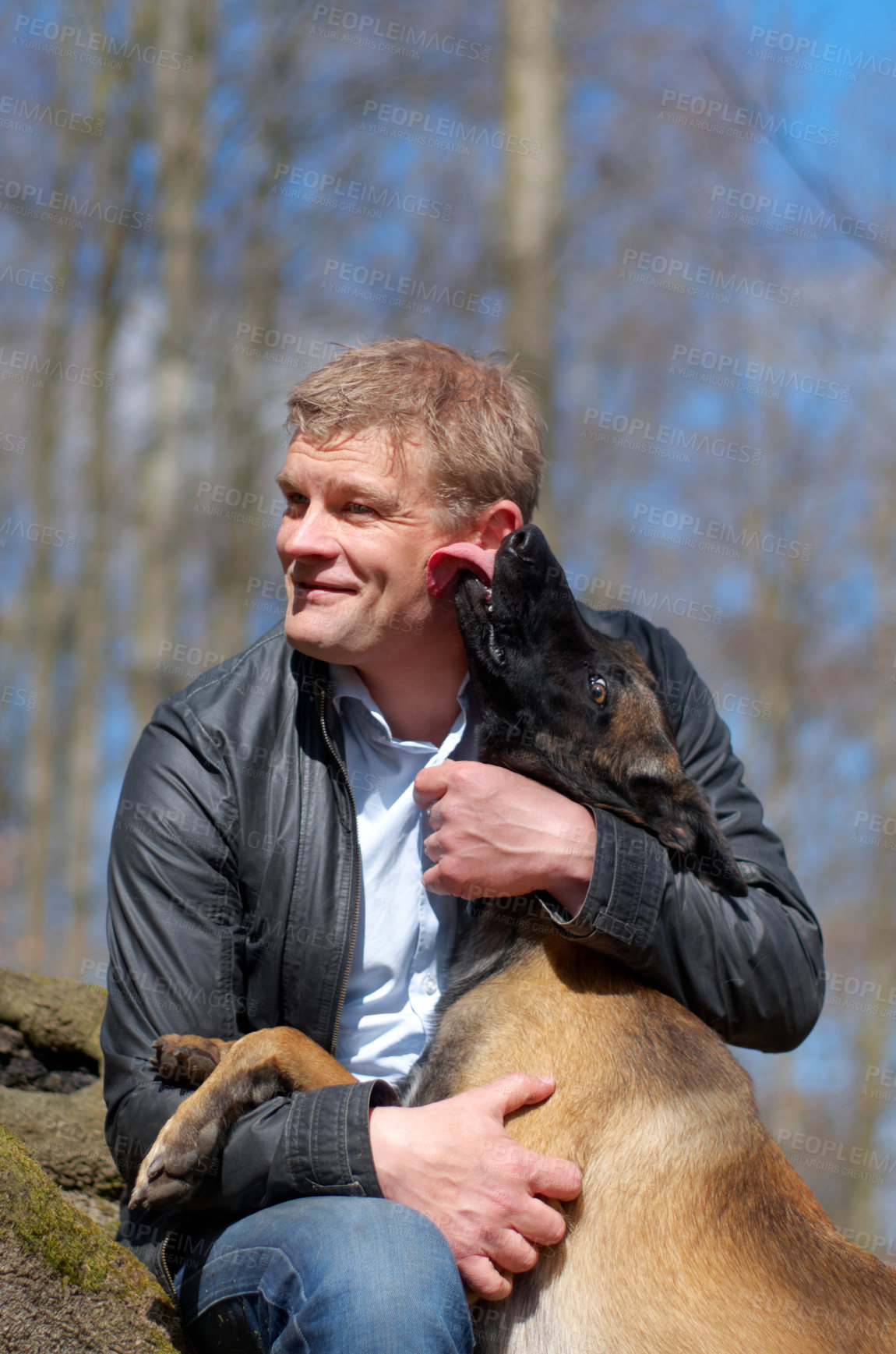 Buy stock photo A man and his dog sitting in the forest together