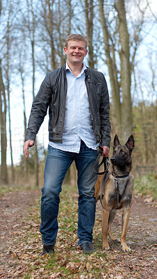 Buy stock photo Shot of a man going for a walk with his dog in the woods