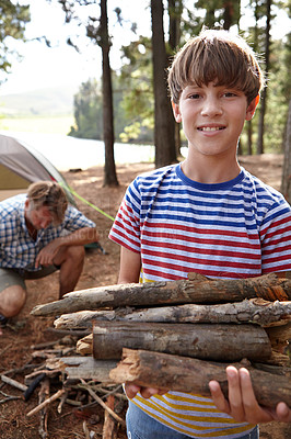 Buy stock photo Boy, dad and camping with firewood in portrait for heat, cooking and learning on outdoor adventure. Child, father and wood in forest for holiday, vacation and happy in nature by trees in Colorado