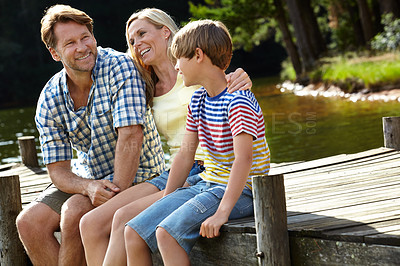Buy stock photo Nature, happy and family by lake for vacation, summer holiday and bonding in forest at countryside. Parents, son and smile with love for travel, weekend adventure and tourism together in Europe