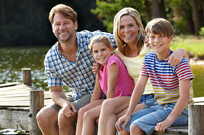 Buy stock photo Parents, lake and kids on jetty for portrait, hug and happy on vacation, relax and nature in summer. Mom, dad and children with smile, care or bonding with family for love on holiday in Colorado