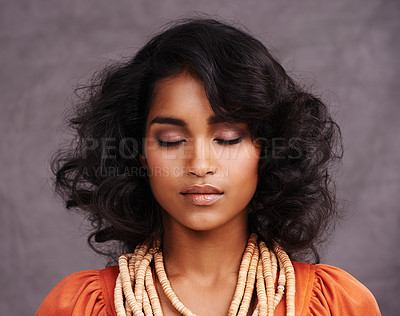 Buy stock photo Indian woman, face and fashion in studio with eyes closed on grey background with beauty and jewelry. Closeup,  female person and makeup with traditional necklaces, outfit and heritage look. 