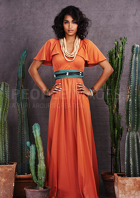 Buy stock photo Indian woman, fashion and confident with jewelry in studio on grey background with cacti props and dress. Portrait, female person and outfit with traditional necklace, trendy and creative look. 