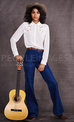 Buy stock photo Woman, fashion and musician cowgirl in studio, western clothing and guitar with confidence. Native American, female person in serious portrait for trendy countryside culture, isolated on background