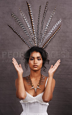 Buy stock photo Indian woman, fashion and feathers with jewelry in studio on black background for heritage or culture. Portrait, female person and confident with traditional necklaces or accessory and hands up