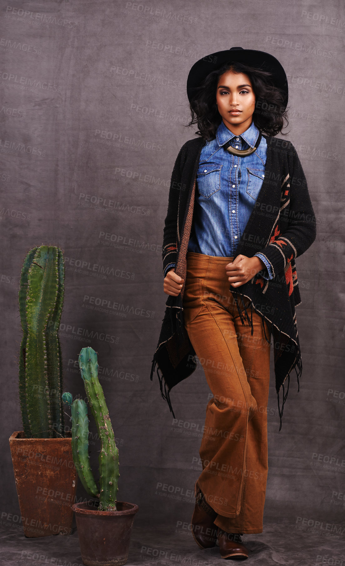 Buy stock photo Cactus, fashion or woman in cowgirl, portrait, wild west culture and cool clothes in studio on grey background. Native American person, western lady and stylish model with pride, boho style or plants