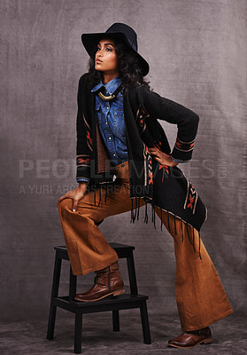 Buy stock photo Culture, cowgirl or woman thinking in studio, wild west and cool fashion or clothing on grey background. Native American person, western lady and stylish model with pride, boho style and chair stool