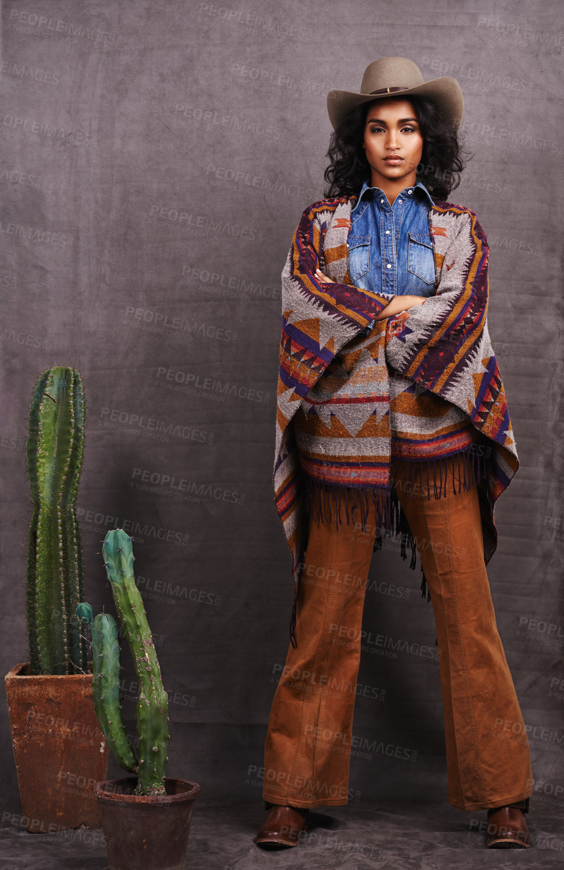 Buy stock photo Cactus, fashion or cowgirl in style, portrait, wild west culture or cool clothes in studio on grey background. Confident person, western woman or stylish model with pride, boho outfit or plants