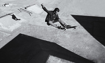 Buy stock photo Man, jump and skateboard at skatepark for training with practice or hobby to play tricks. Monochrome, exercise and experience on break or leisure to enjoy for activity, sport and fitness with passion