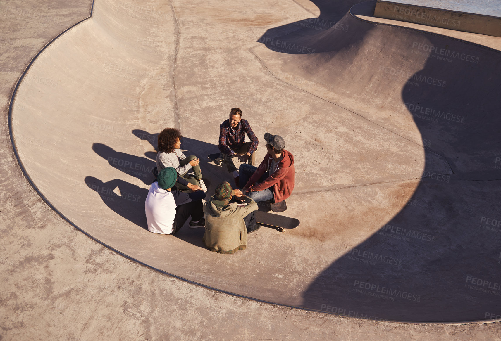 Buy stock photo Sunshine, skate park and friends with conversation, relax and communication with weekend break or group. People, outdoor or skaters with summer or recreation with diversity or support with discussion