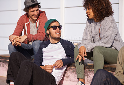 Buy stock photo Shot of a group of friends hanging out in the sun