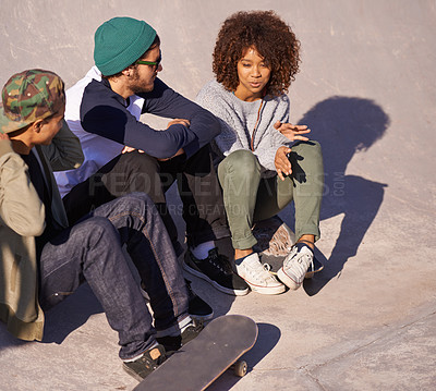 Buy stock photo Shot of a group of friends hanging out at a skate park