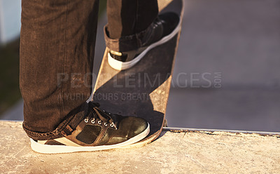 Buy stock photo Closeup, skateboard and person with sneakers, sunshine and training with technique and fitness. Skater, practice and shoes with fitness, talent and performance with weekend break and skating culture