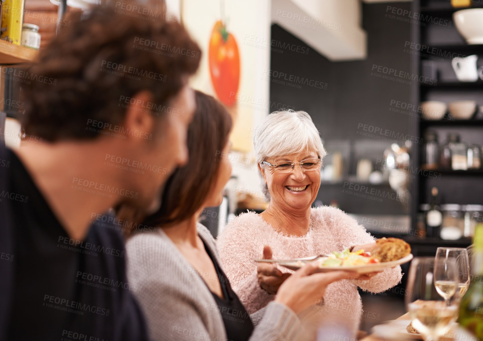 Buy stock photo Shot of a family sitting down to dinner