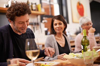 Buy stock photo Happy, eating and family at dinner in dining room for party, celebration or event at modern home. Smile, bonding and group of people enjoying meal, supper or lunch together with wine at house.