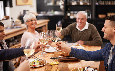 Buy stock photo Shot of a family sitting down to dinner