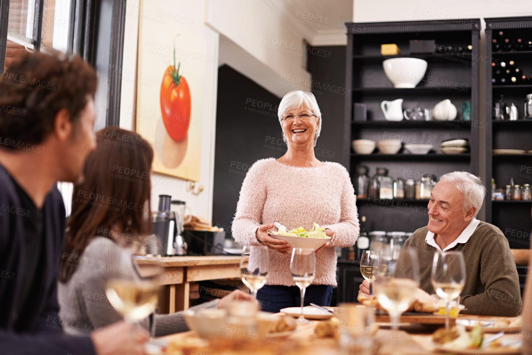 Buy stock photo Shot of a family sitting down to dinner