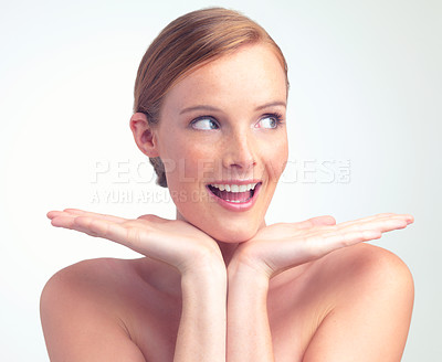 Buy stock photo A studio portrait of a beautiful young woman with her face in her hands