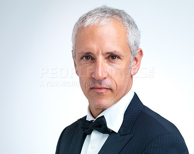Buy stock photo Portrait, mature man and tuxedo in studio with confidence, designer fashion and stylish in white background. Serious, elegant and male person with pride in suit, fancy and cool style in mockup space