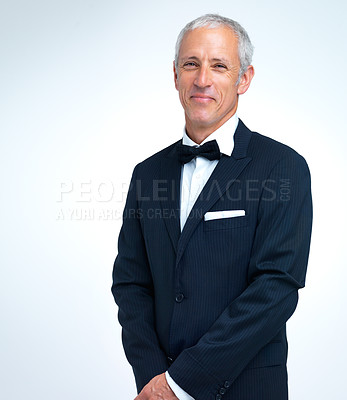 Buy stock photo Mature man, portrait and tuxedo in studio, elegant and designer fashion on white background. Male person, smile and confidence in suit for formal event or party, fancy style and proud of aesthetic