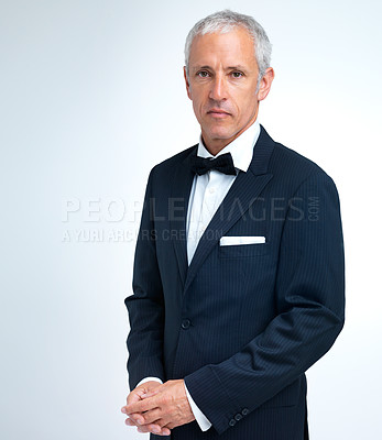 Buy stock photo A studio shot of a mature man in a tuxedo