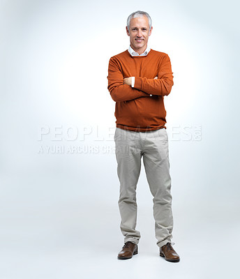Buy stock photo Mature man, portrait and arms crossed in a studio with modern style, fashion and smile. Happy, senior and old male person with white background with confidence and casual jersey alone with joy