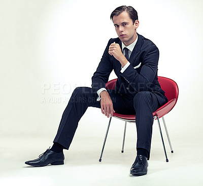 Buy stock photo Portrait, man and retro suit on chair in studio and serious in formal fashion by white background. Young model, face and confidence in elegant clothes for event, relax and class in tuxedo by party