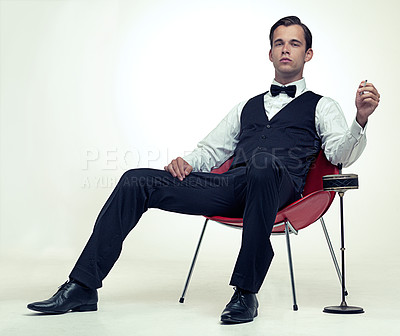 Buy stock photo Fashion, gentleman and portrait with tuxedo and cigarette for stylish, trend and habit with suit and luxury. Young person and sit with confidence for vintage, wealthy and handsome for rich on mockup