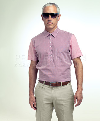 Buy stock photo Mature man, confident or trendy as fashion, apparel or stylish outfit in studio on white background. Assertive, businessman or sunglasses as smart, casual or leisure wear to relax on getaway