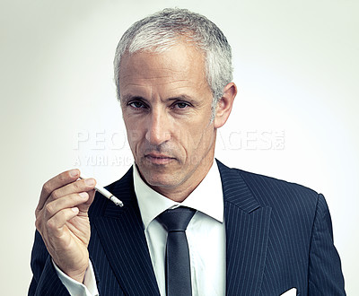 Buy stock photo Portrait, mature and businessman smoking cigarette with salesman in studio isolated on a gray background. Face, suit and serious man with tobacco, ceo and manager with vintage fashion in Australia