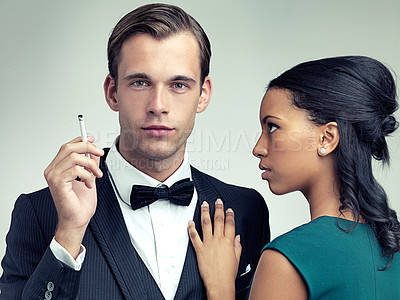 Buy stock photo Cigarette, fashion and portrait of couple in studio with elegant, formal and stylish clothes for event. Luxury, party and man and woman smoking with confidence, pride and glamour on gray background