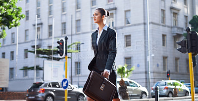 Buy stock photo A young businesswoman walking in the city on her way to work