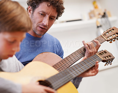 Buy stock photo Learning, guitar and teacher in music with child in lesson and development of skill on instrument. Playing, practice and man helping kid in education with advice as musician mentor in acoustic sound
