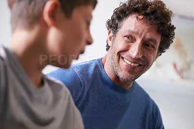 Buy stock photo Home, son and father with smile, happiness and proud of child, growth and development of boy. House, adult and man listening to kid talk as parent with love, support and care for family in apartment