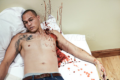 Buy stock photo Cropped shot of a male corpse lying on a blood splattered bed