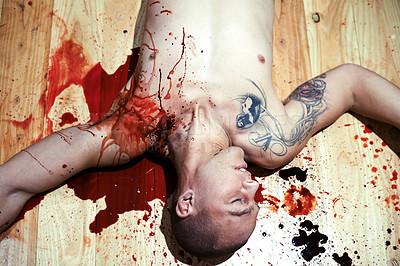 Buy stock photo Cropped shot of a male corpse lying on a blood splattered floor