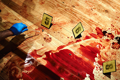 Buy stock photo Cropped shot of a bloody crime scene floor with a hand collecting evidence