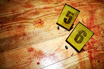 Buy stock photo Shot of Cropped shot two bullet casings on a bloody crime scene floor