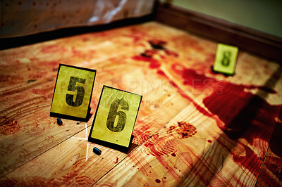 Buy stock photo Shot of two bullet casings on a bloody crime scene floor