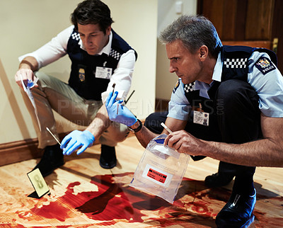 Buy stock photo Shot of two investigators going over a crime scene