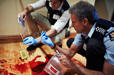 Buy stock photo Shot of two investigators going over a crime scene