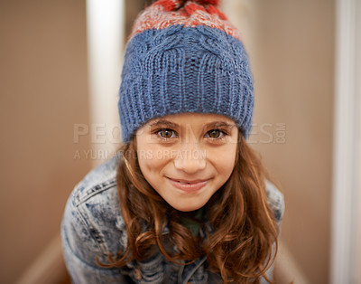 Buy stock photo Shot of a young girl posing in her woolen hat indoors